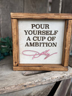 DOLLY PARTON FRAMED COWHIDE SIGN - POUR YOURSELF A CUP OF AMBITION!